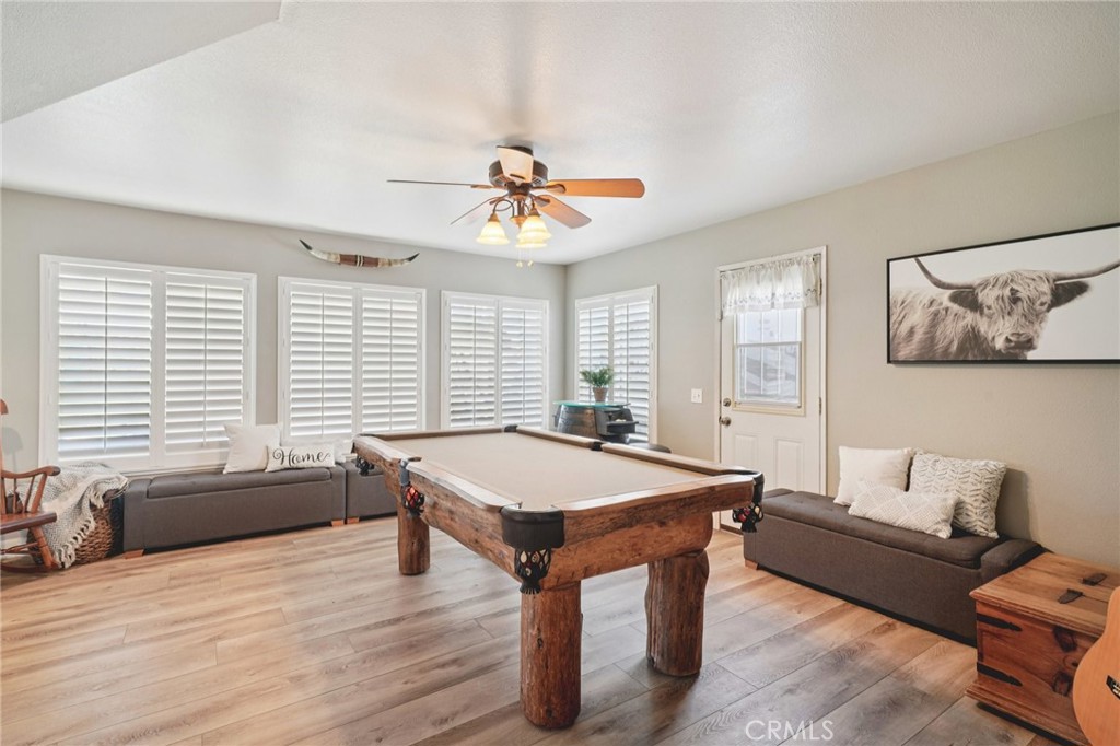 2821 Riding Ring Road Norco, CA 92860 - Photo 19 of 54 a room with a table chairs and wooden floor