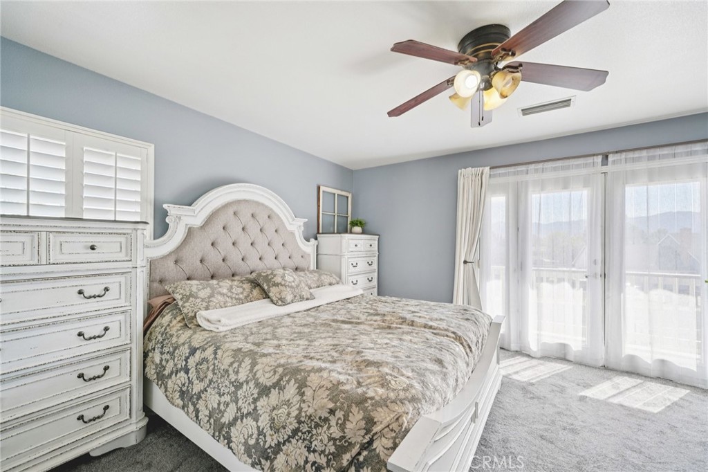 2821 Riding Ring Road Norco, CA 92860 - Photo 31 of 54 a bedroom with a large bed and a chandelier