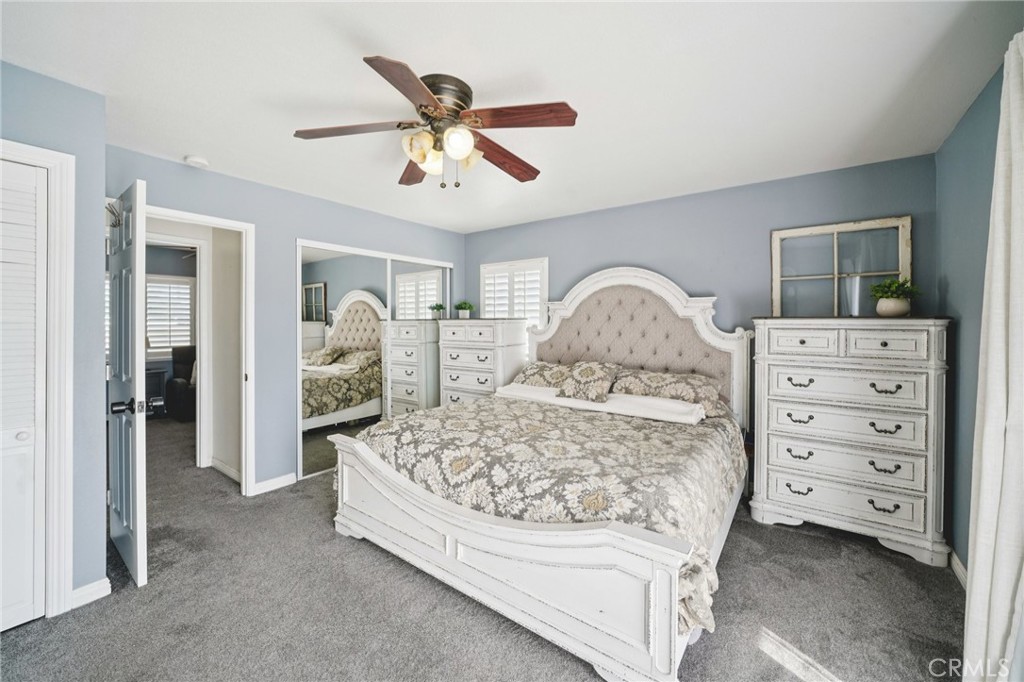2821 Riding Ring Road Norco, CA 92860 - Photo 32 of 54 a spacious bedroom with a bed and a chandelier