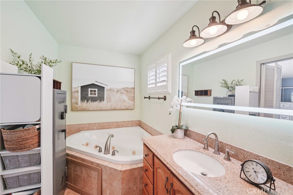 2821 Riding Ring Road Norco, CA 92860 - Photo 34 of 54 a bathroom with a granite countertop bathtub a sink and mirror