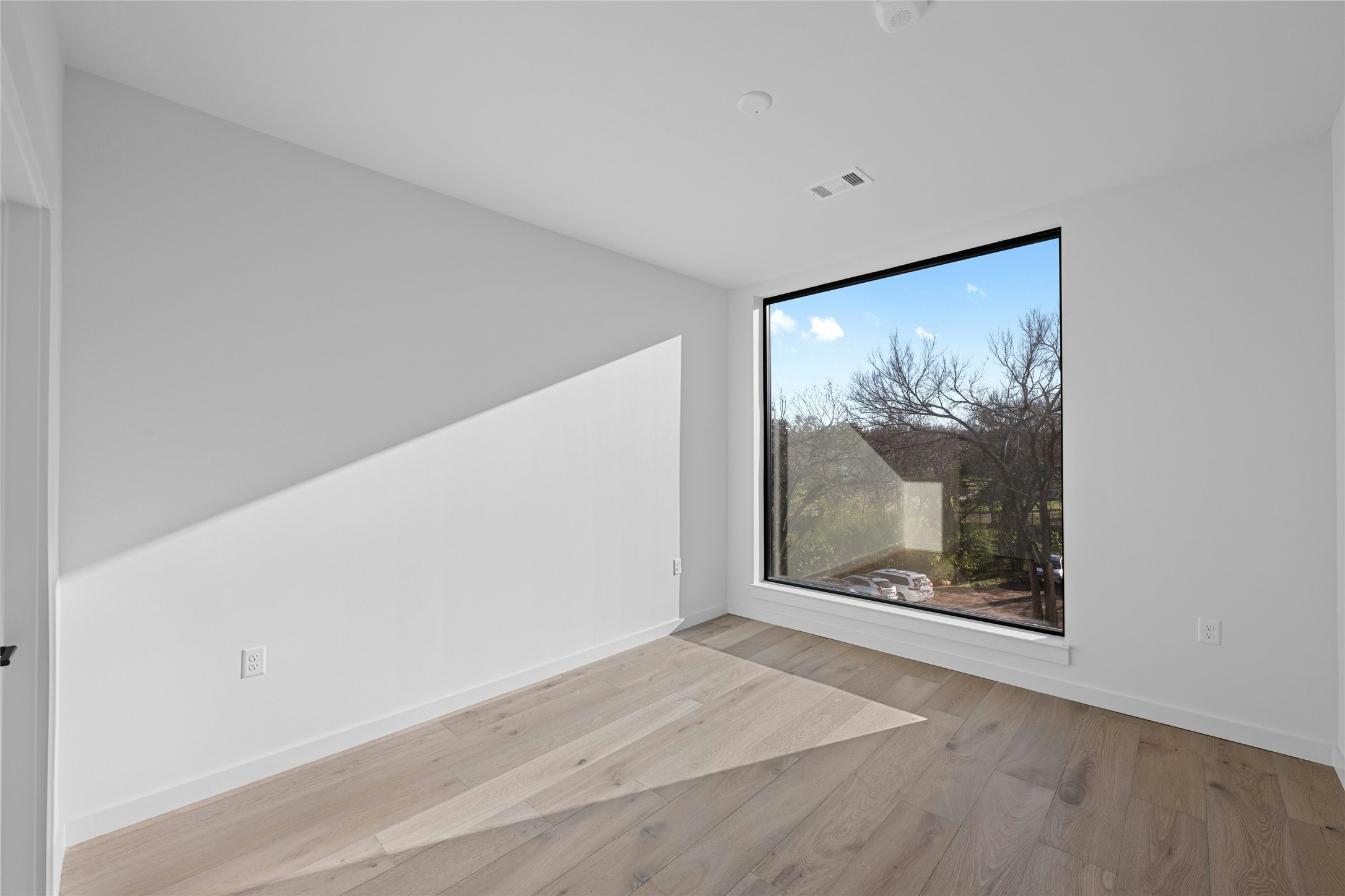 2209 South 1st Street, Unit 321 Austin, TX 78704 - Photo 14 of 40 Unfurnished room featuring light wood-style flooring and baseboards