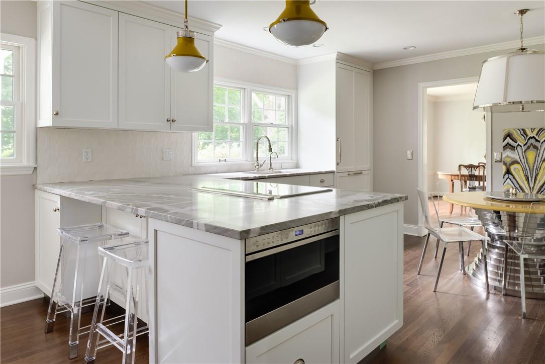 a kitchen with a stove and white cabinets