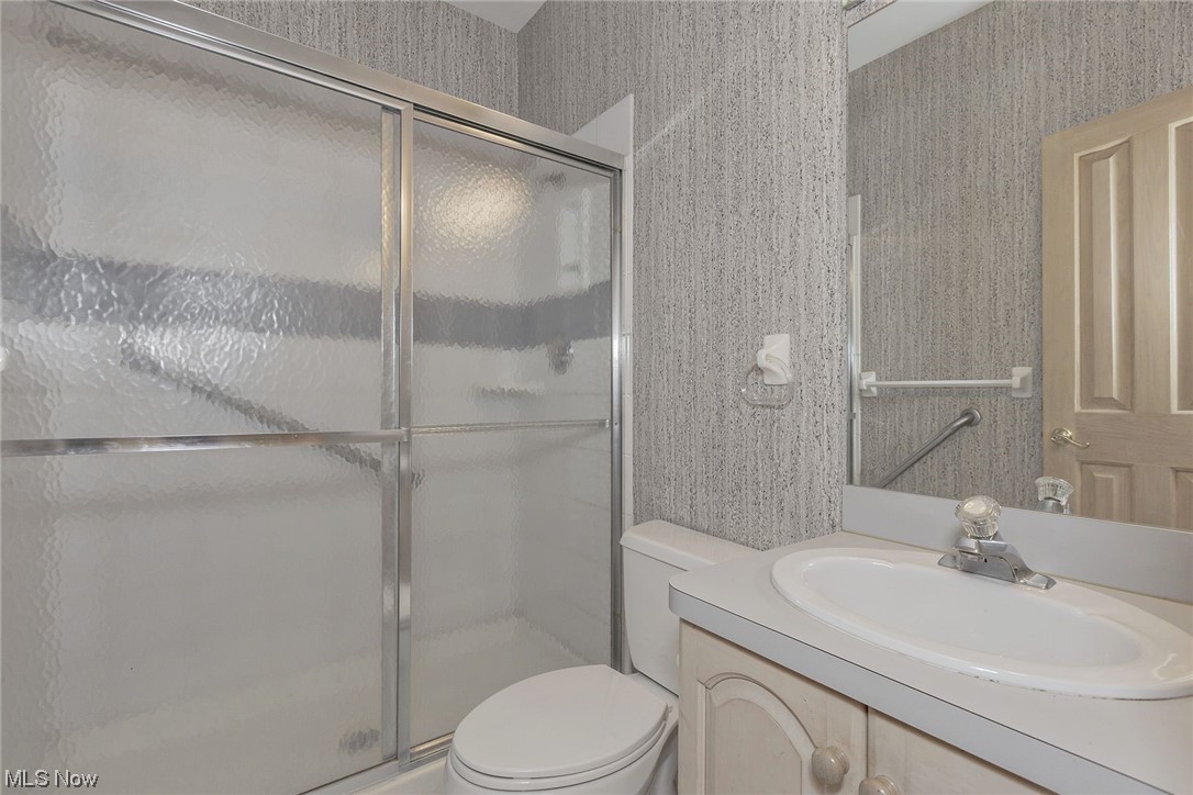 3850 Ellendale Road Moreland Hills, OH 44022 - Photo 16 of 39 Full Bathroom on first floor featuring walk in shower, toilet, and vanity