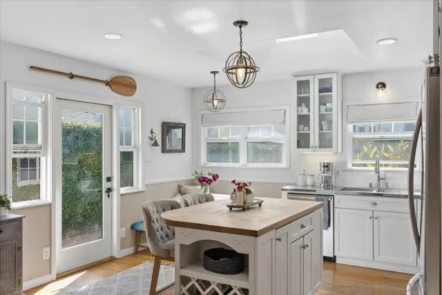 a kitchen with a sink a stove and cabinets