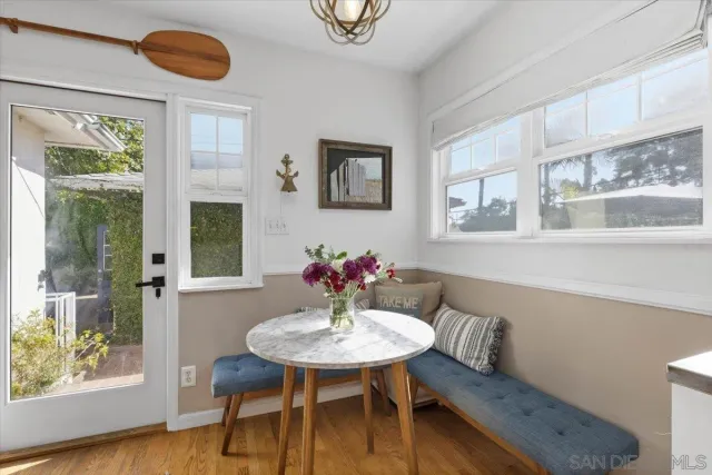 a view of a dining room with furniture and wooden floor