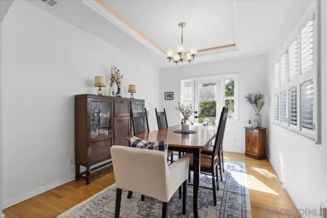 a view of a dining room with furniture and chandelier