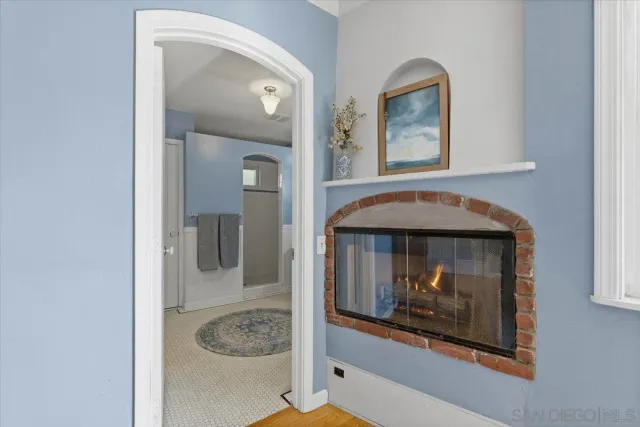 a room with a mirror and lamp