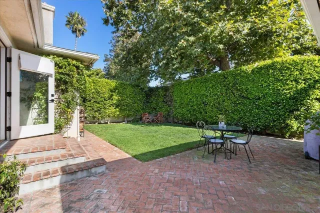 a view of a patio with table and chairs and potted plants