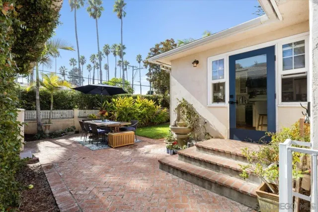 a view of a patio with table and chairs potted plants