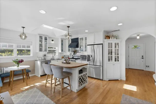 a kitchen with refrigerator and chairs