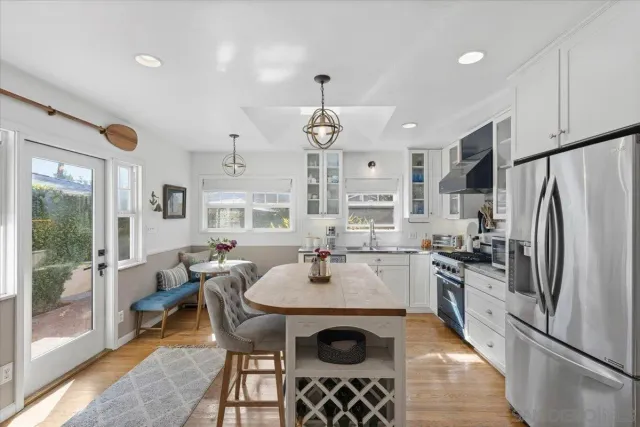 a kitchen with a dining table and chairs