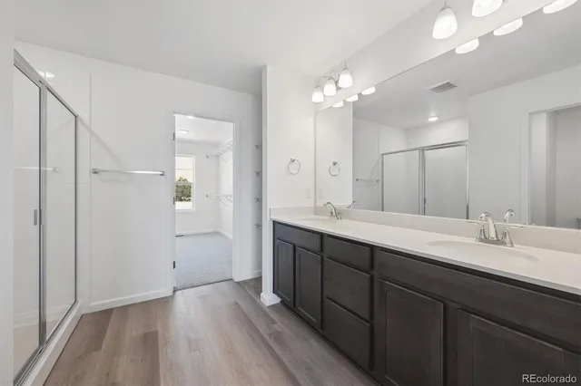 a bathroom with a double vanity sink and a mirror