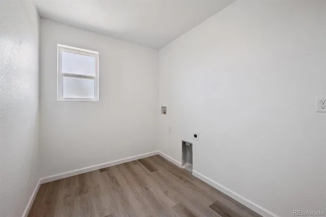 a view of small space with wooden floor and window
