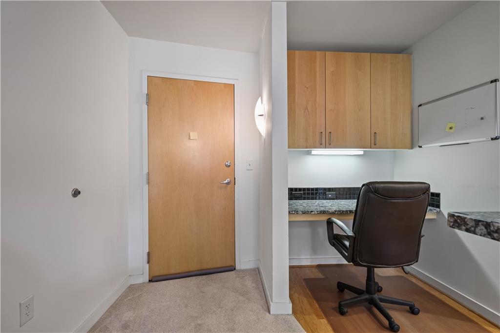 250 Pharr Road Northeast, Unit 606 Atlanta, GA 30305 - Photo 4 of 31 a view of a workspace with furniture and a window