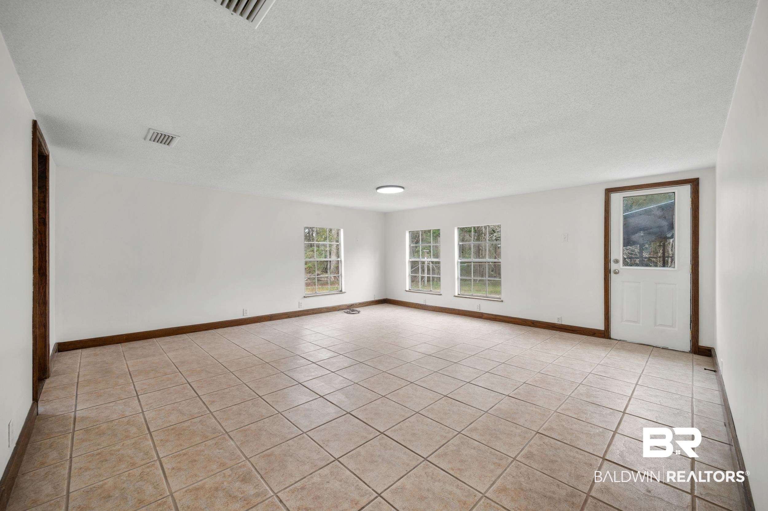 35780 Spring Road North Stapleton, AL 36578 - Photo 7 of 41 Spare room with a textured ceiling and light tile patterned flooring