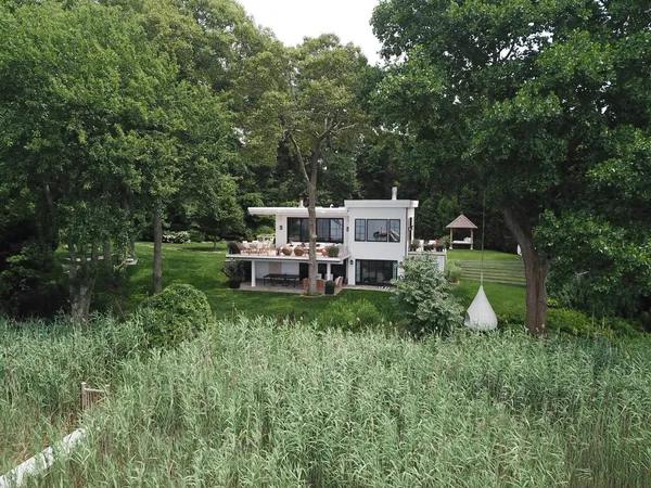 a house view with a sitting space and garden