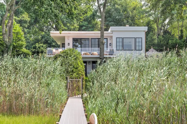 a view of a house with brick walls and flower plants