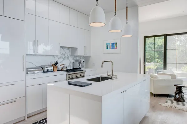 a kitchen with a sink a stove and cabinets