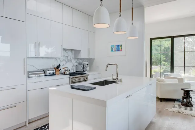 a kitchen with a sink a stove and cabinets