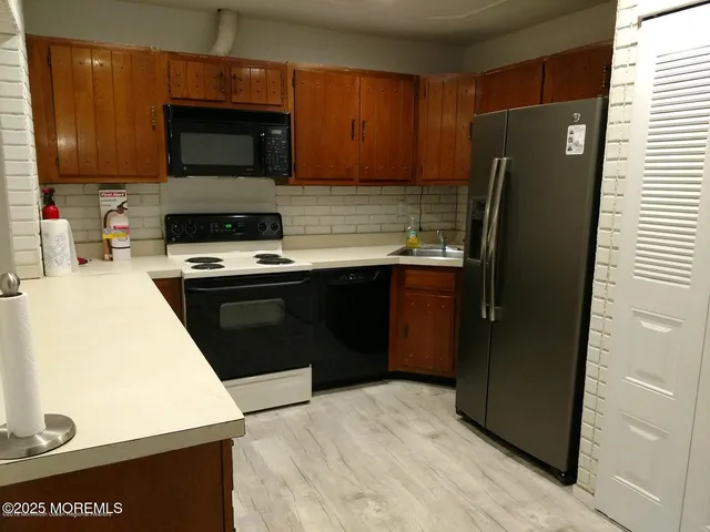 a view of a kitchen with a sink and cabinets