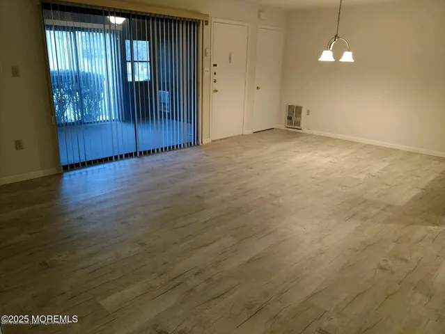 a view of an empty room with a chandelier