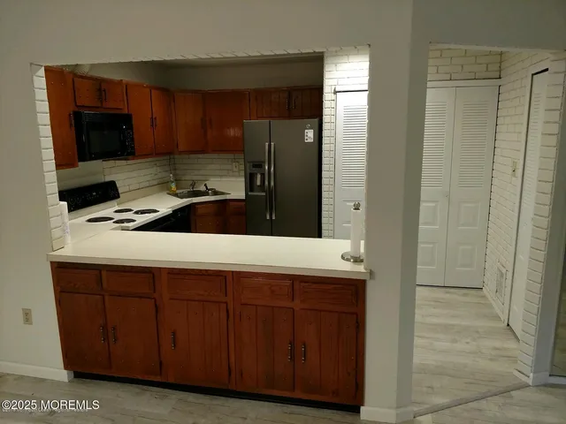 a kitchen with a refrigerator sink and microwave