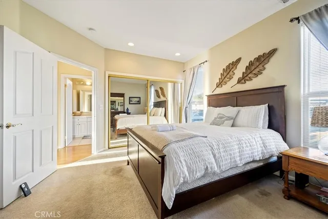 a bedroom with a bed and a mirror