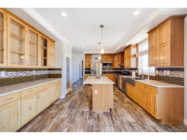 a large kitchen with stainless steel appliances lots of counter space and a window