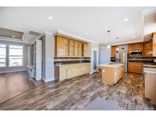 a view of a kitchen with wooden floor