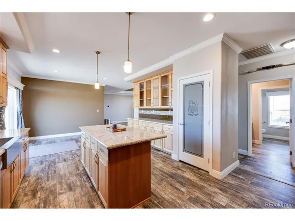 a kitchen with a stove and a wooden floor