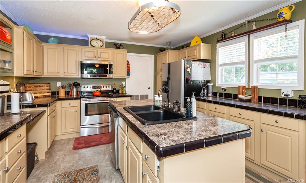2843 Fay Jones Road Denver, NC 28037 - Photo 8 of 27 a kitchen with stainless steel appliances granite countertop a stove a sink and a microwave
