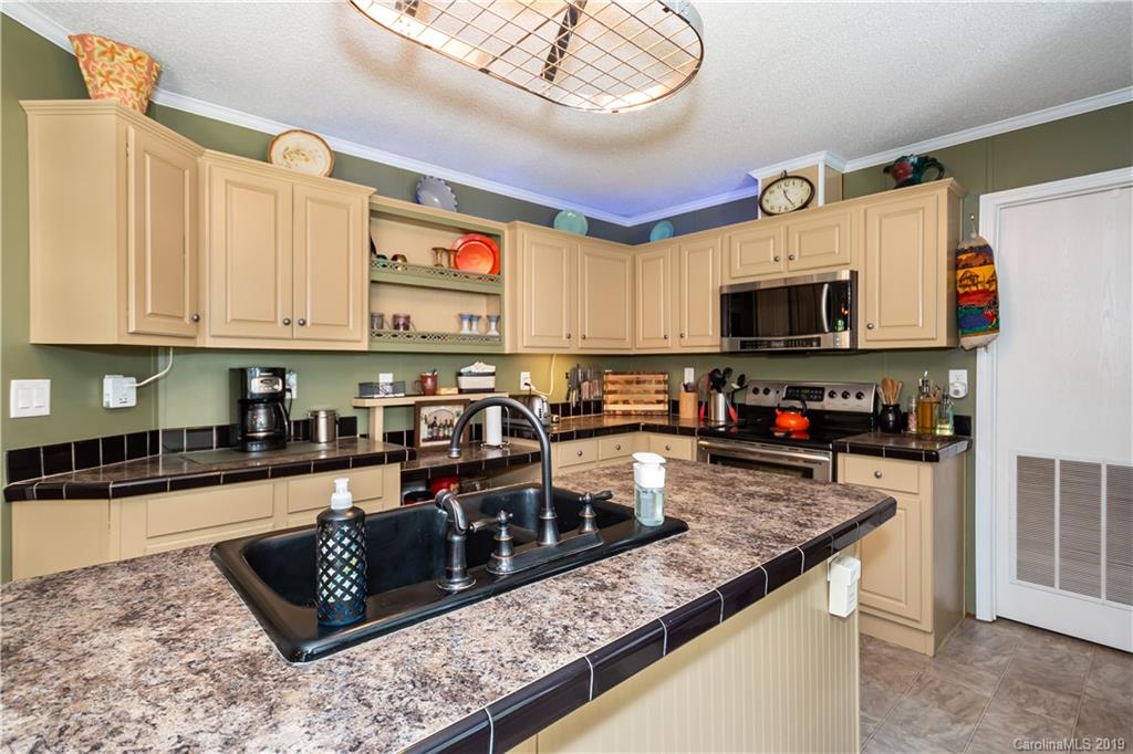 2843 Fay Jones Road Denver, NC 28037 - Photo 10 of 27 a kitchen with stainless steel appliances granite countertop a stove a sink a microwave and refrigerator