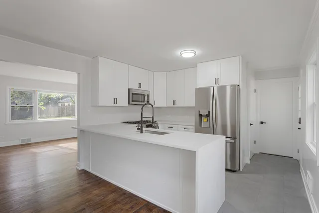 a kitchen with stainless steel appliances a refrigerator and a stove