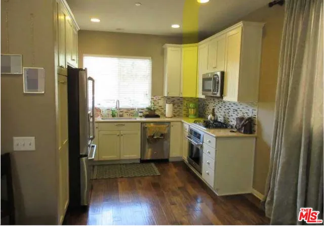 a kitchen with a sink stove and refrigerator