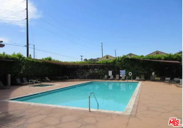 a white building with a yard and palm trees