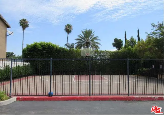 a view of a park with iron fence