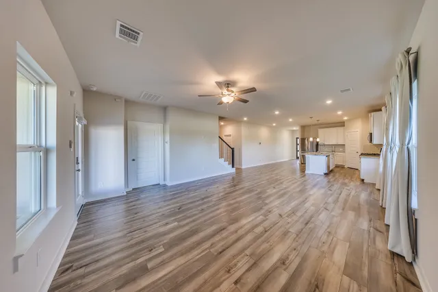 a view of a kitchen with a sink and a wooden floor