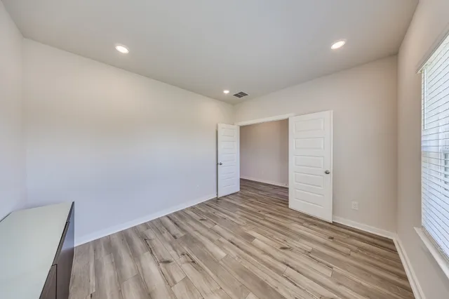 wooden floor in an empty room with a window