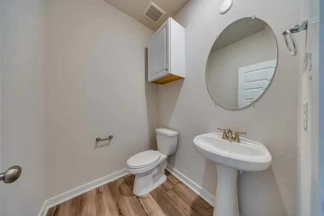 a bathroom with a sink toilet and mirror