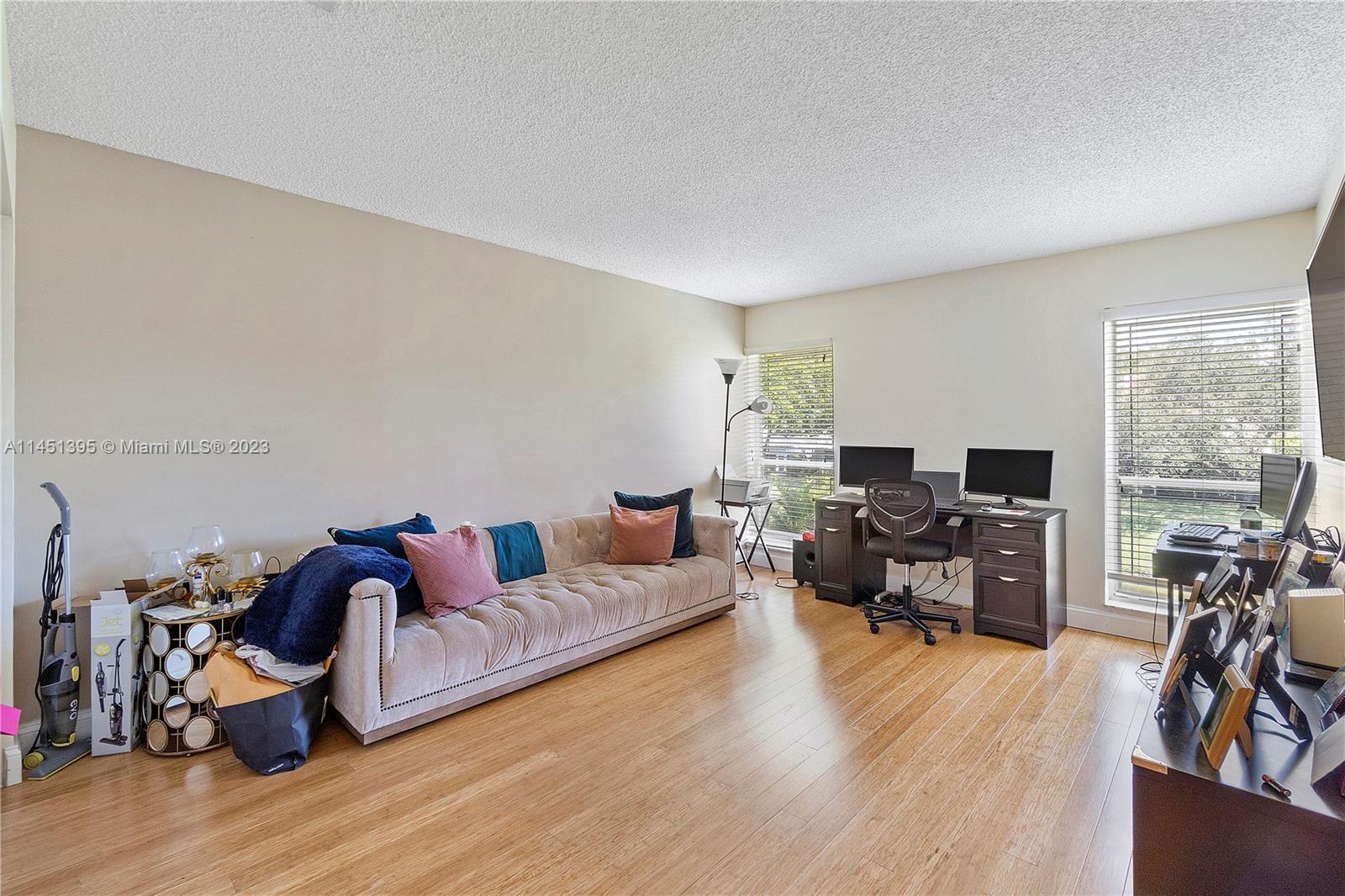 6157 Old Court Road, Unit 225 Boca Raton, FL 33433 - Photo 24 of 27 a living room with furniture and a flat screen tv with wooden floor
