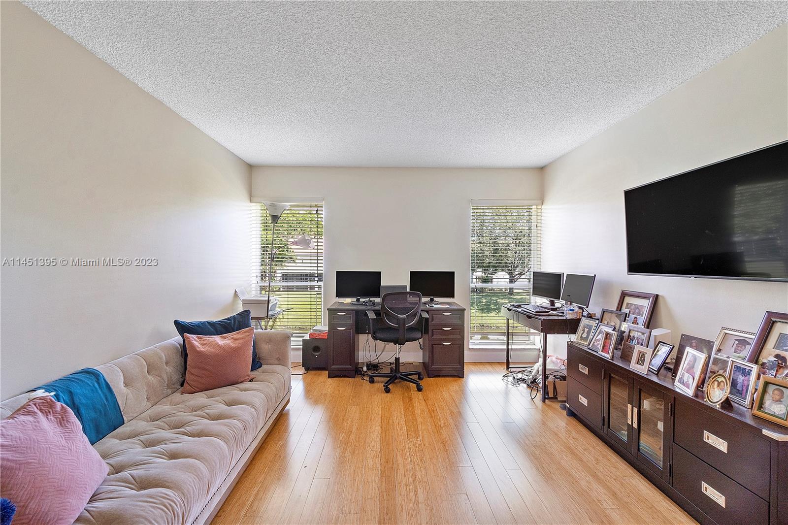 6157 Old Court Road, Unit 225 Boca Raton, FL 33433 - Photo 25 of 27 a living room with furniture and a flat screen tv