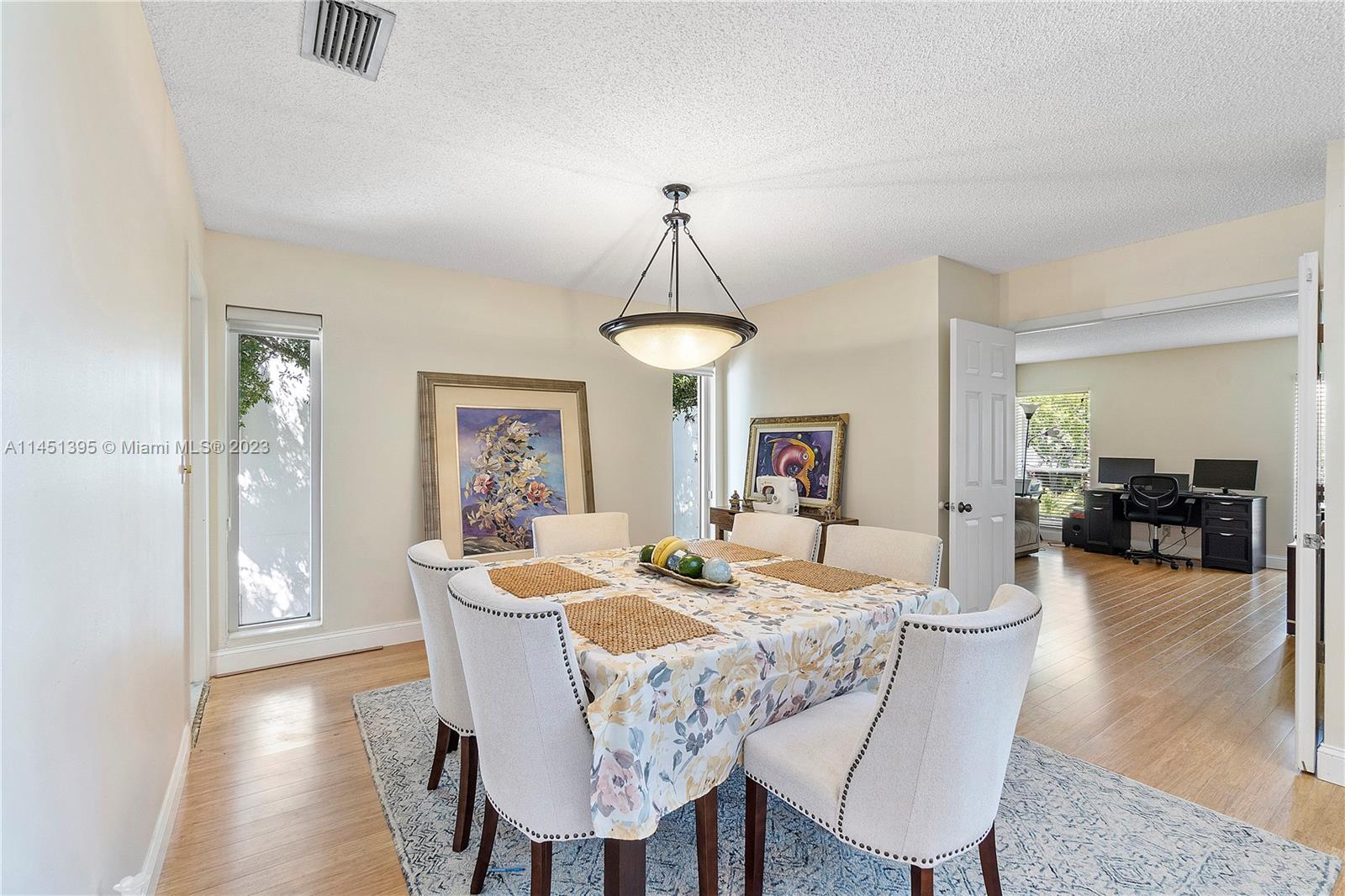 6157 Old Court Road, Unit 225 Boca Raton, FL 33433 - Photo 4 of 27 a view of a dining room with furniture wooden floor and chandelier