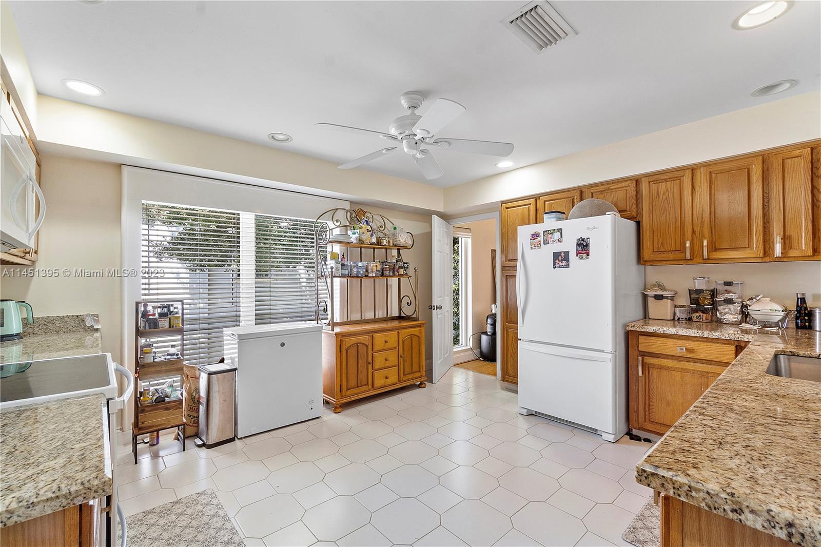 6157 Old Court Road, Unit 225 Boca Raton, FL 33433 - Photo 8 of 27 a kitchen with refrigerator and cabinets
