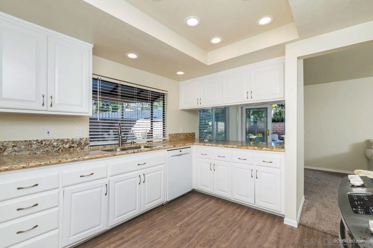 2750 Persimmon Place Riverside, CA 92506 - Photo 8 of 23 a kitchen with white cabinets and sink