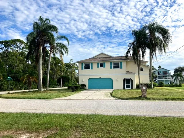 a house with palm tree in front of it