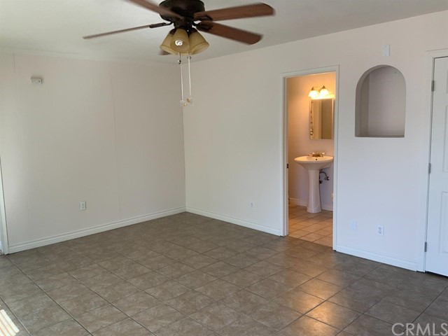9450 Mango Avenue Hesperia, CA 92345 - Photo 12 of 14 an empty room and a bathroom with a bathroom