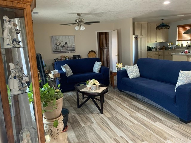 9450 Mango Avenue Hesperia, CA 92345 - Photo 2 of 14 a living room with furniture and a chandelier