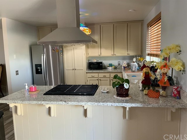9450 Mango Avenue Hesperia, CA 92345 - Photo 3 of 14 a kitchen with a refrigerator and a sink