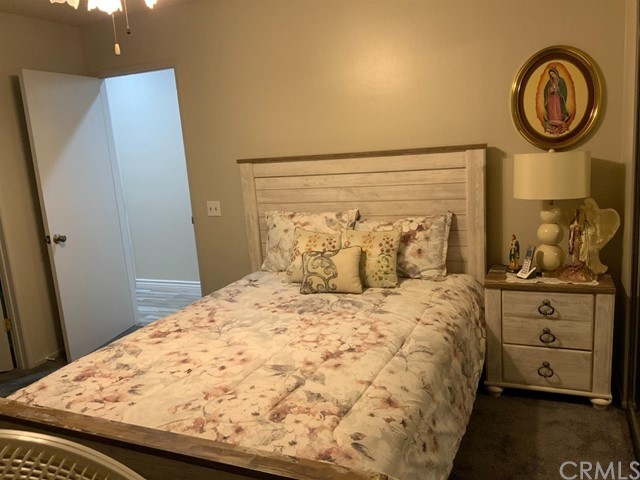 9450 Mango Avenue Hesperia, CA 92345 - Photo 6 of 14 a bedroom with a bed and a dresser in it