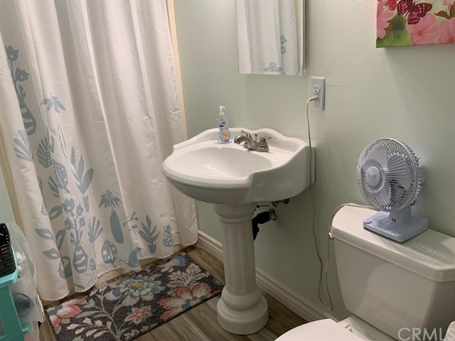 9450 Mango Avenue Hesperia, CA 92345 - Photo 7 of 14 a bathroom with a granite countertop sink and a mirror
